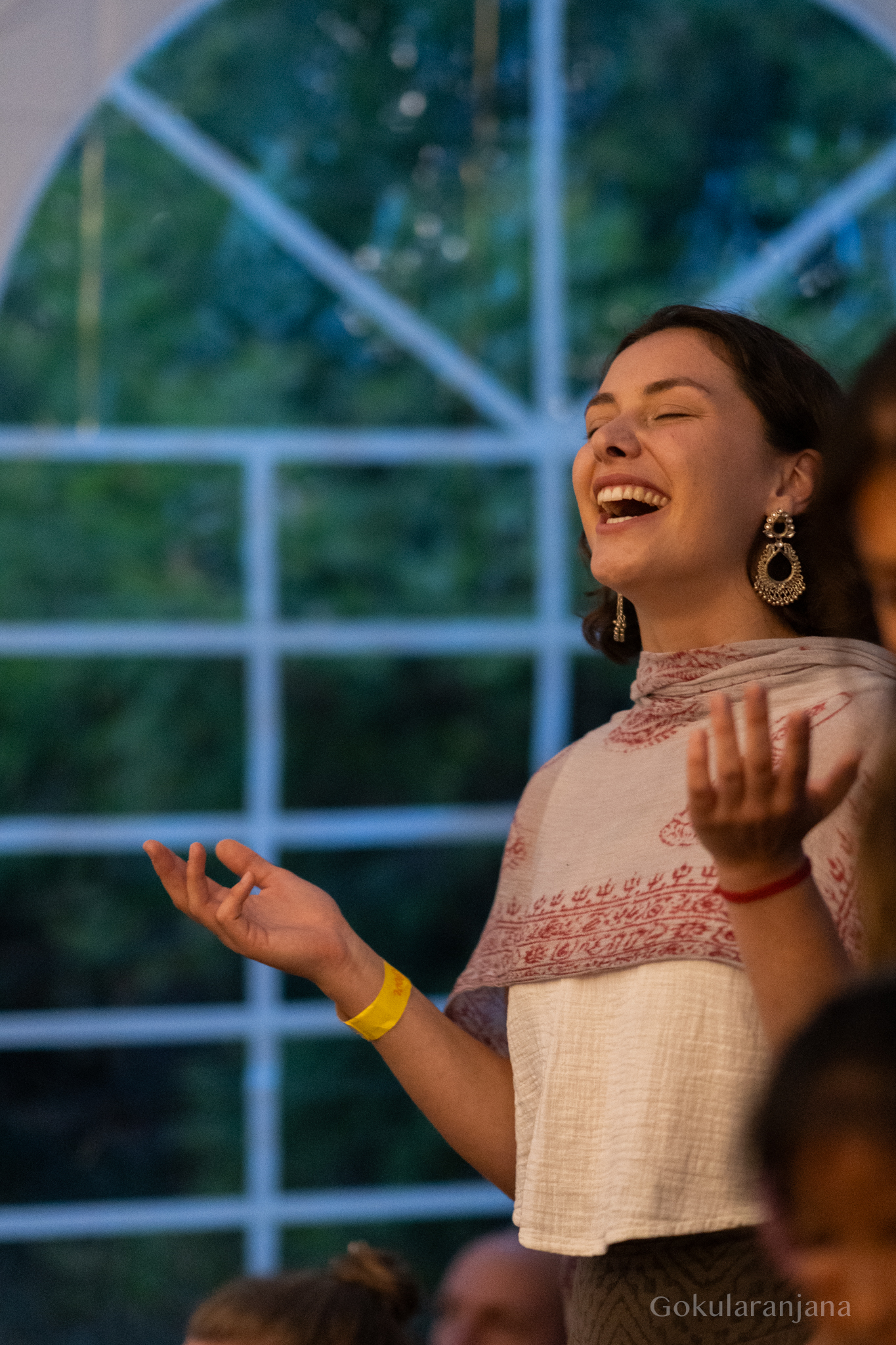 Eine Teilnehmerin singt mit sichtbarer Freude beim Kirtan